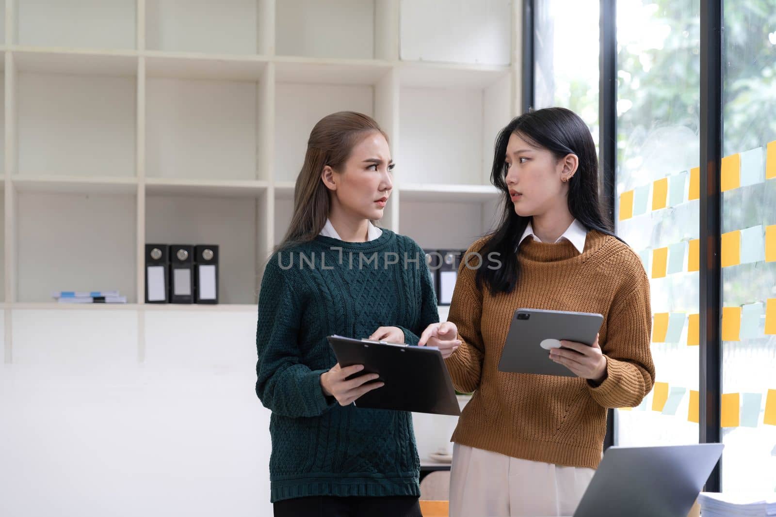 team asian woman thinking hard concerned about online problem solution looking at laptop screen, worried serious asian businesswoman focused on solving difficult work computer task by wichayada