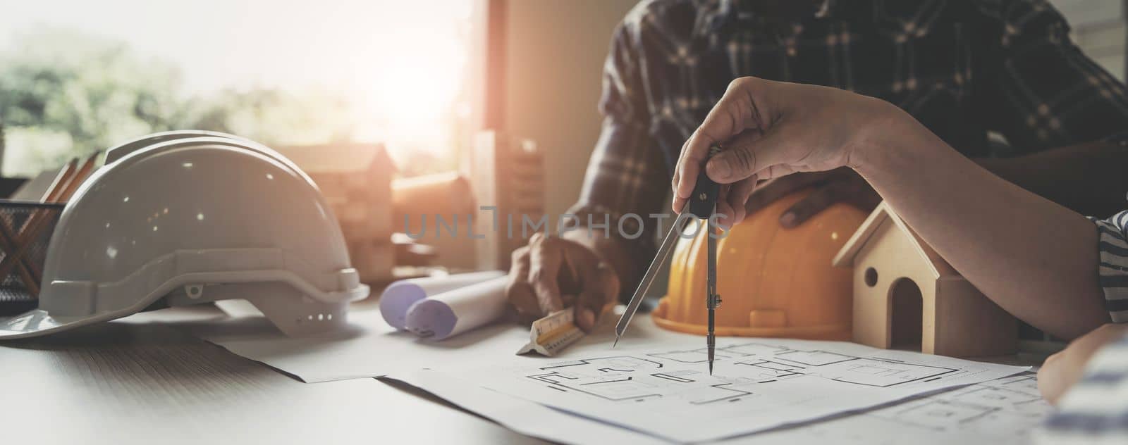 Builder two asian young engineer man and architect woman are discussing construction from a plan to follow the project to build an industrial plant at site. Worker concept. by wichayada