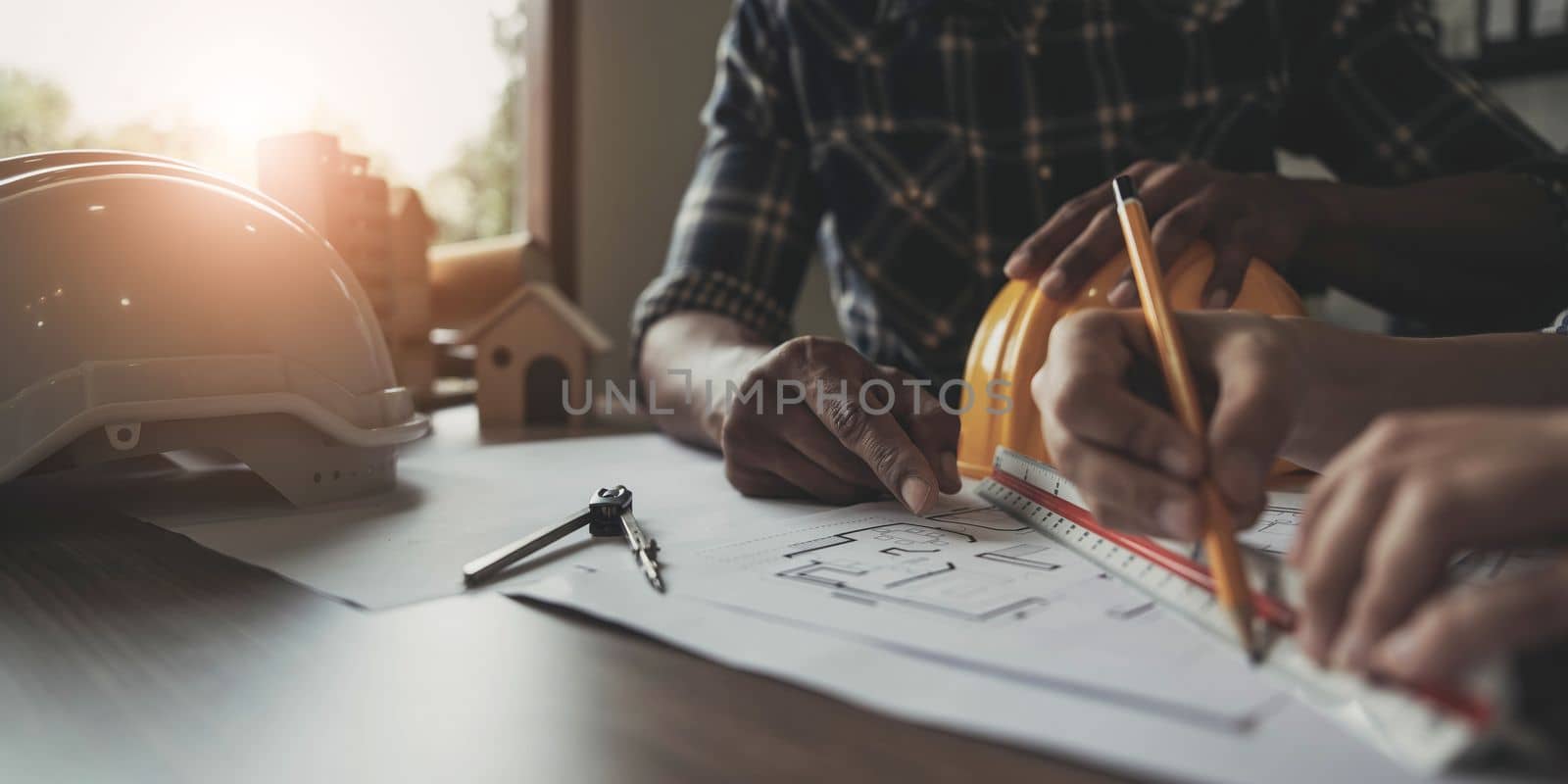 Builder two asian young engineer man and architect woman are discussing construction from a plan to follow the project to build an industrial plant at site. Worker concept..