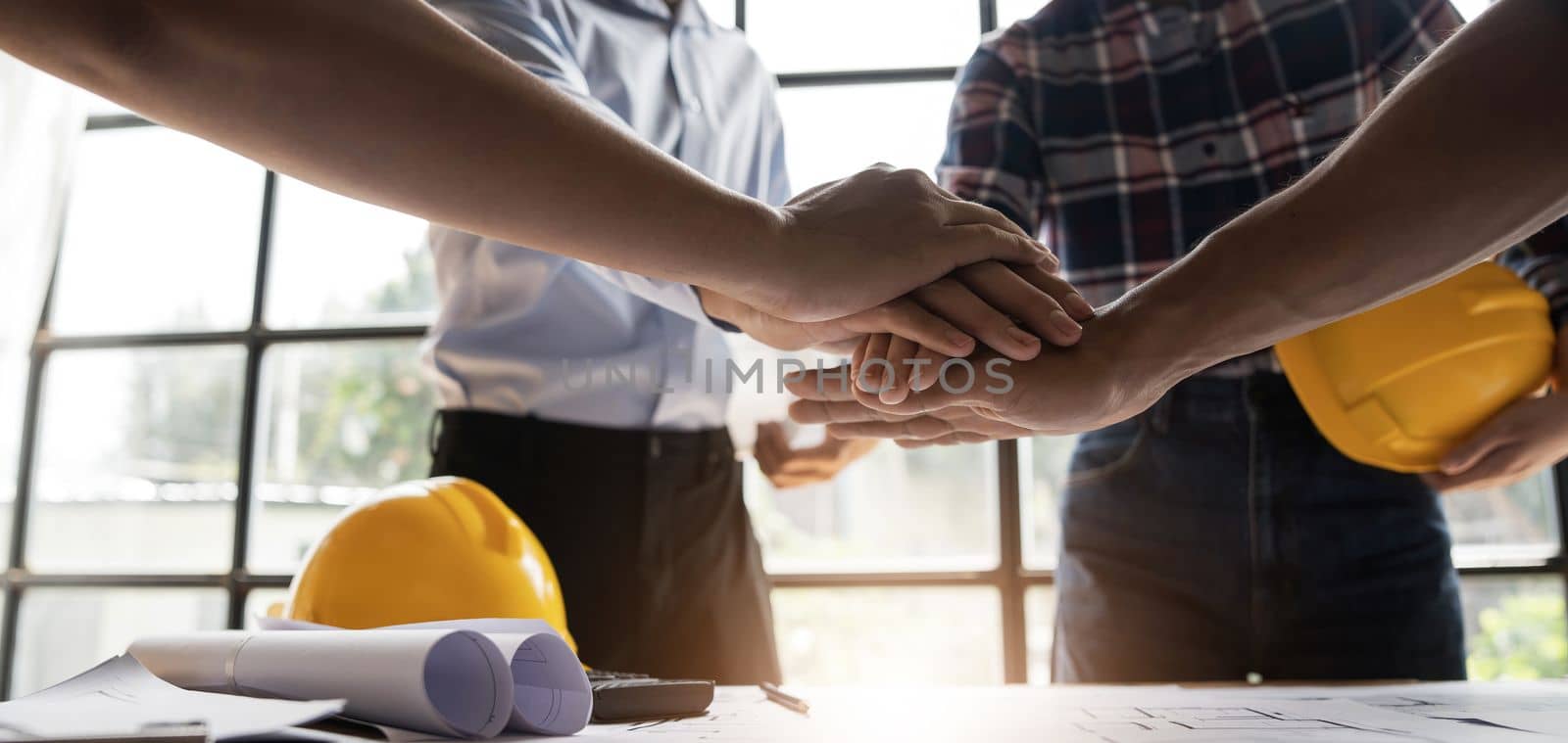 Team of engineer and architects working join hands to build successful projects. Teamwork concept