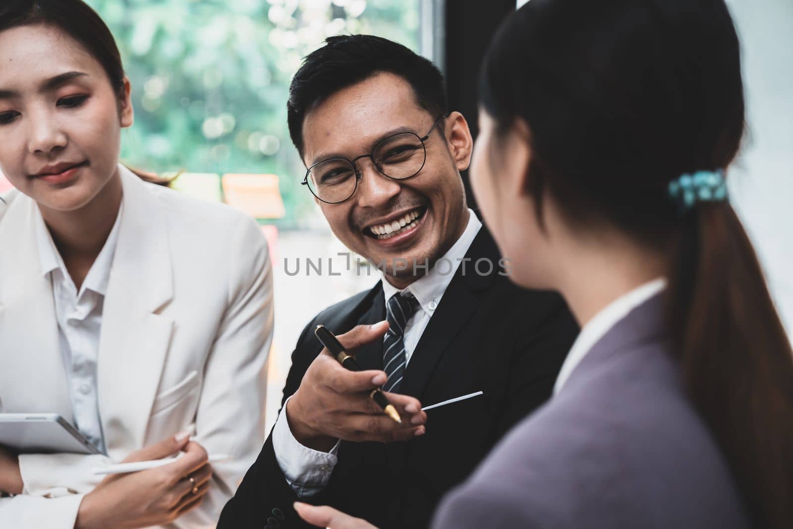 Asian business adviser meeting to analyze and discuss the situation on the financial report in the meeting room.Investment Consultant, Financial advisor and accounting concept.