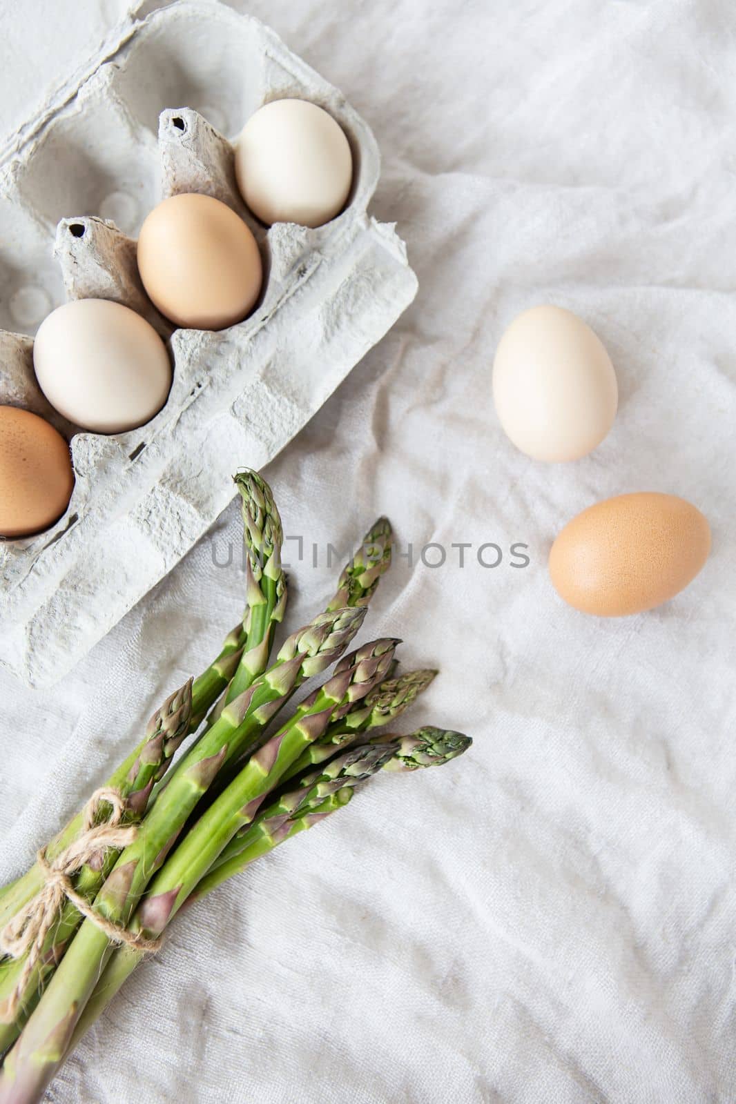 Asparagus and eggs on a fabric linen background. The concept of a healthy and healthy breakfast. Place for an inscription. by sfinks