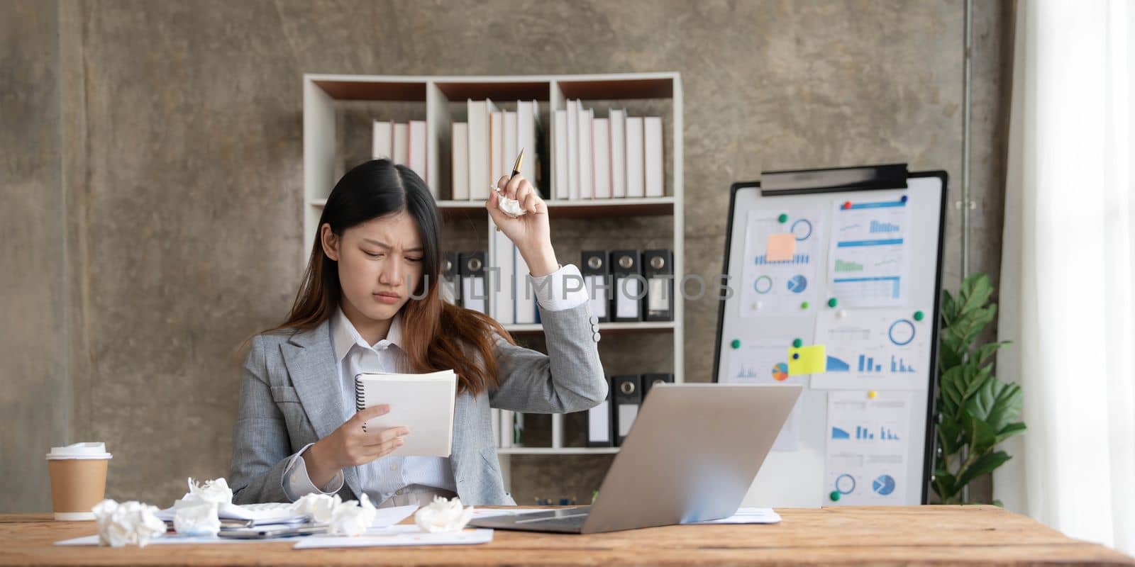 asian woman thinking hard concerned about online problem solution looking at laptop screen, worried serious asian businesswoman focused on solving difficult work computer task..