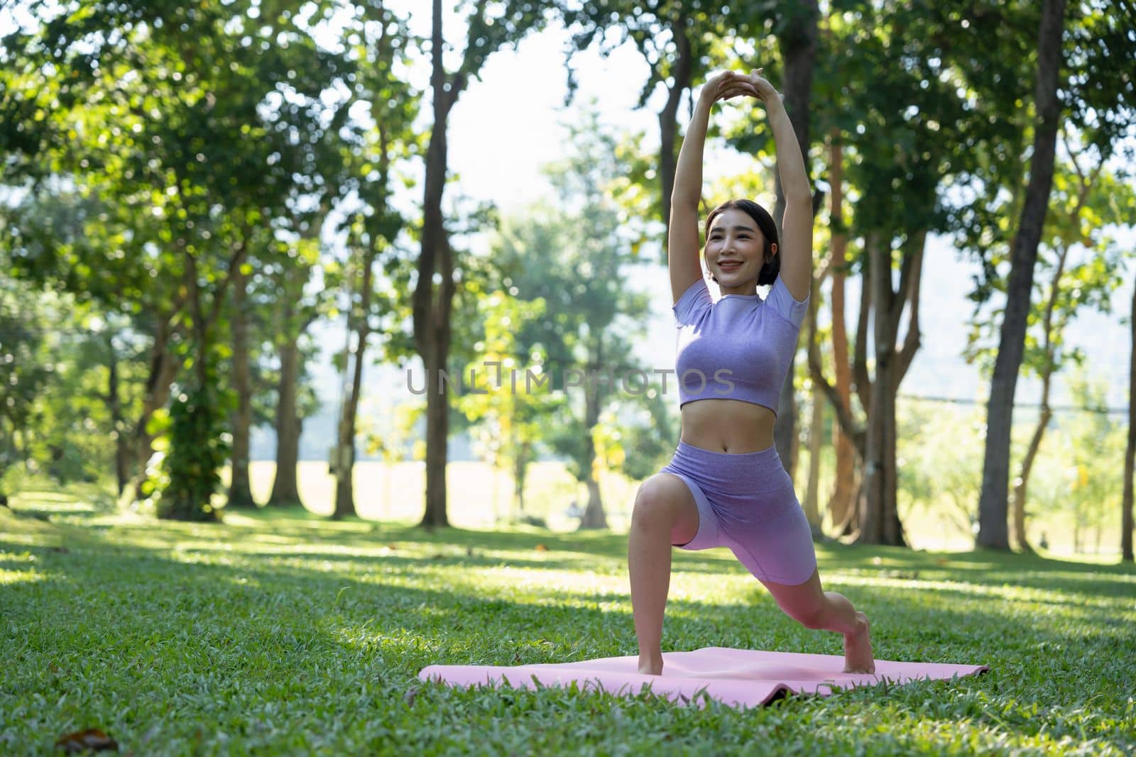 Mature healthy people doing yoga at park. Asian woman exercising on green grass with yoga mat. by nateemee