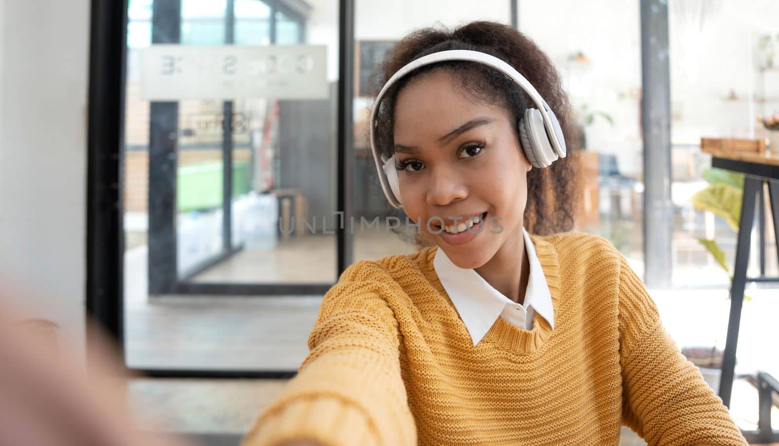 Good mood lady with expansive smile enjoying started weekends and taking selfie on mobile phone on blurred background.