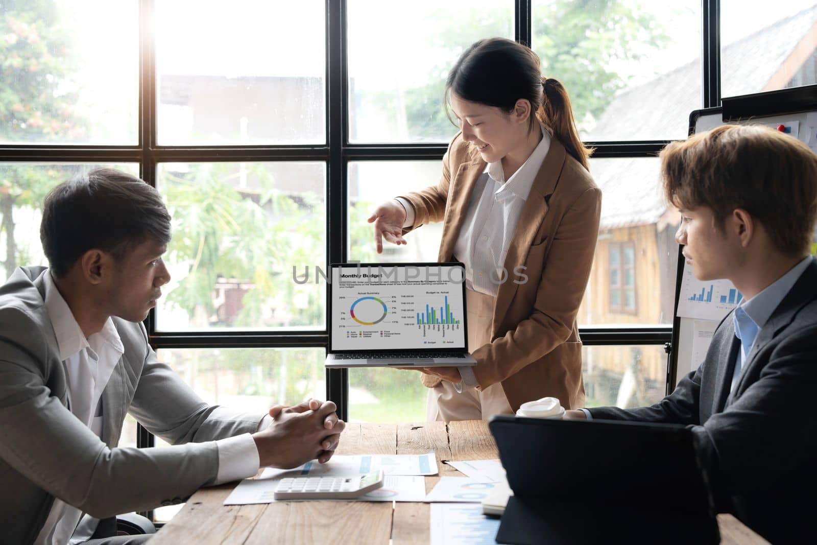 Asian business adviser meeting to analyze and discuss the situation on the financial report in the meeting room.Investment Consultant, Financial advisor and accounting concept..