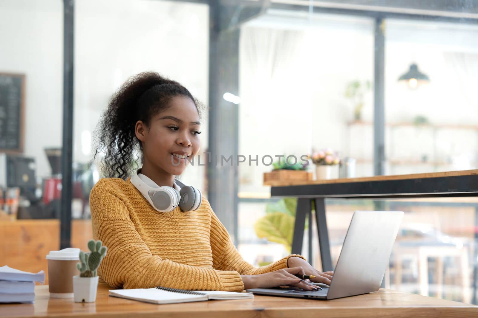 Young woman student using computer and mobile device studying online. Education and online learning..