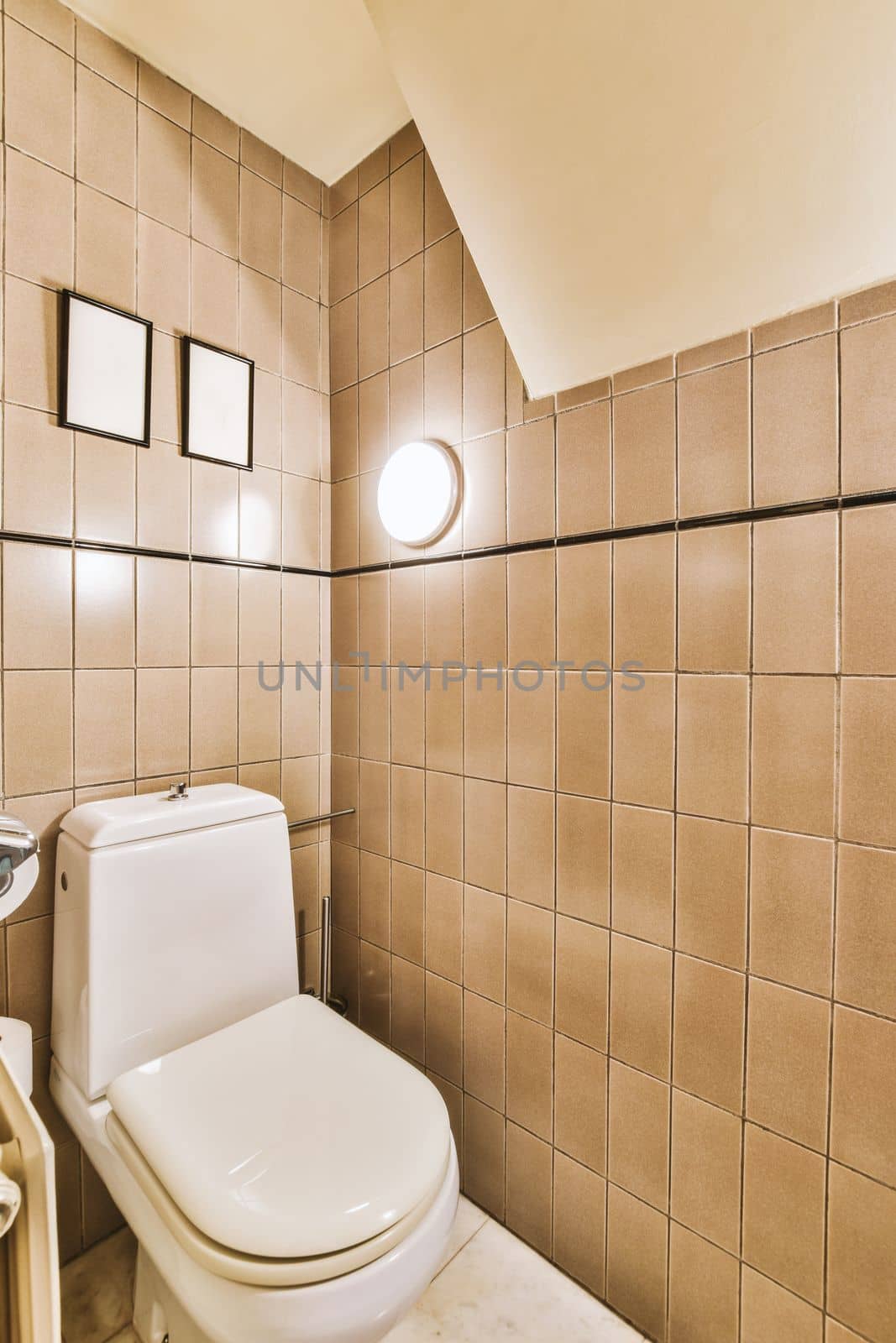 Interior of narrow restroom with sink and wall hung toilet with white walls and checkered floor