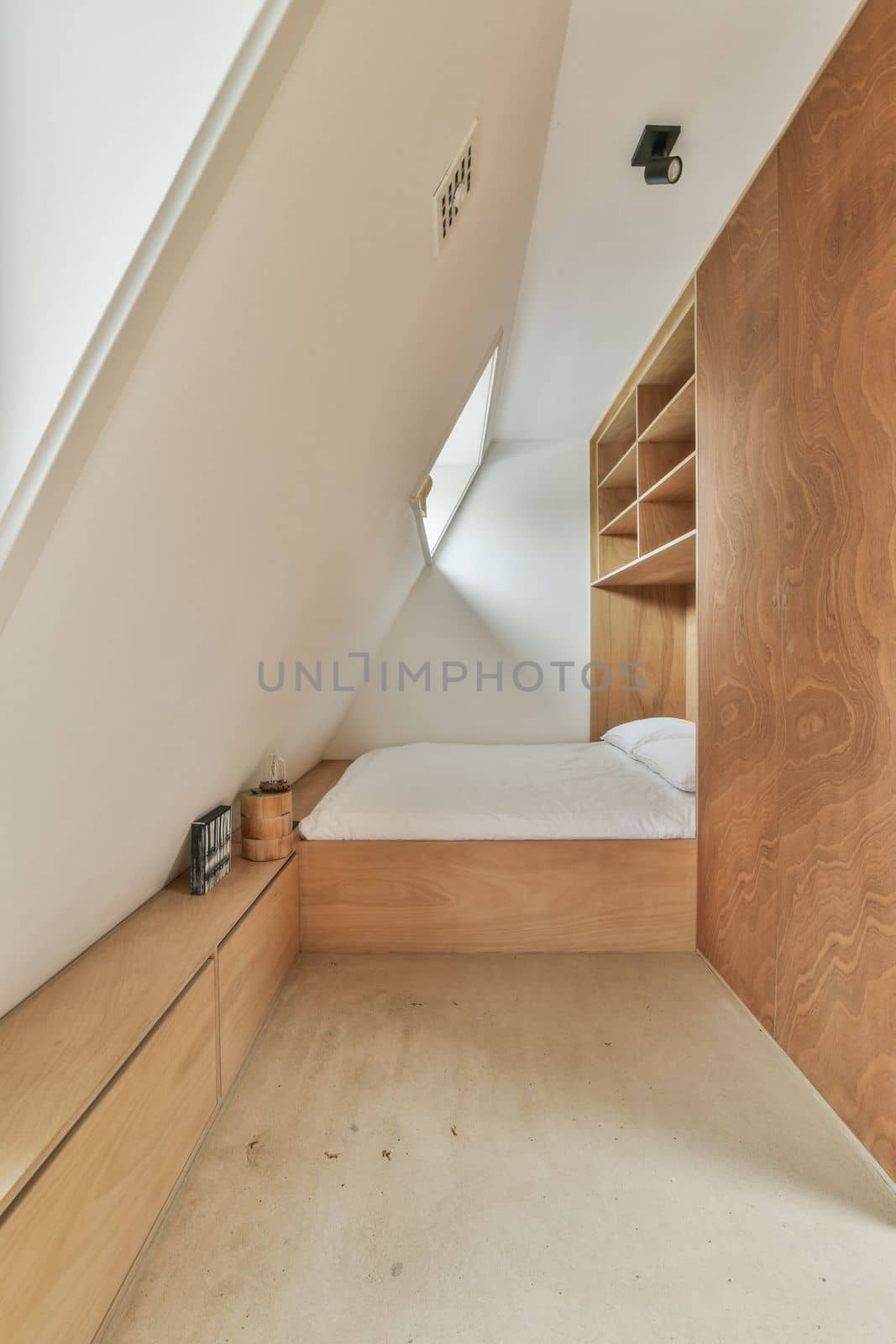 a bedroom with a bed and cupboards on the wall next to each other room in an attic style home
