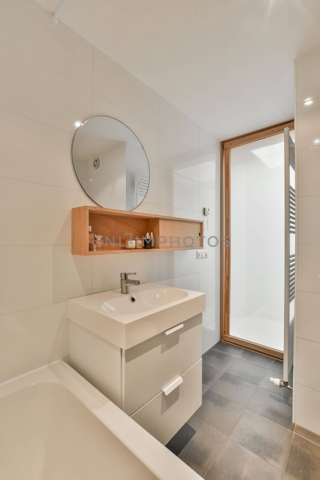 a bathroom with a sink, mirror and bathtub on the wall next to it is an open shower door