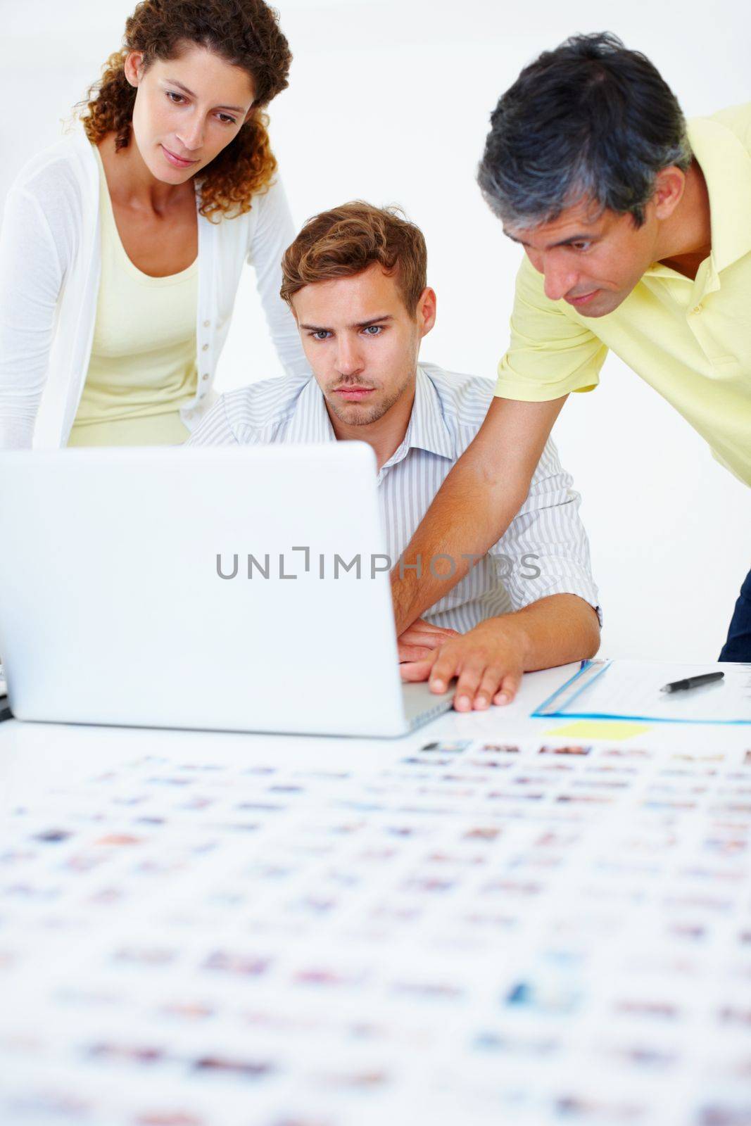 Business people using laptop. Three business people using laptop and looking at the screen