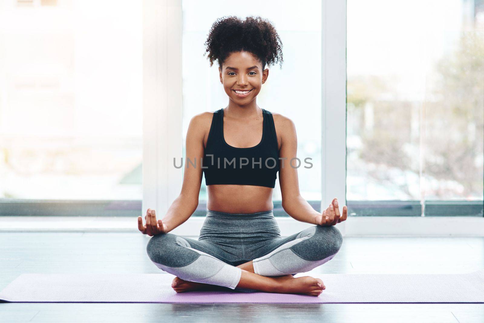 Yoga is always the answer. a beautiful young woman practising yoga in a studio