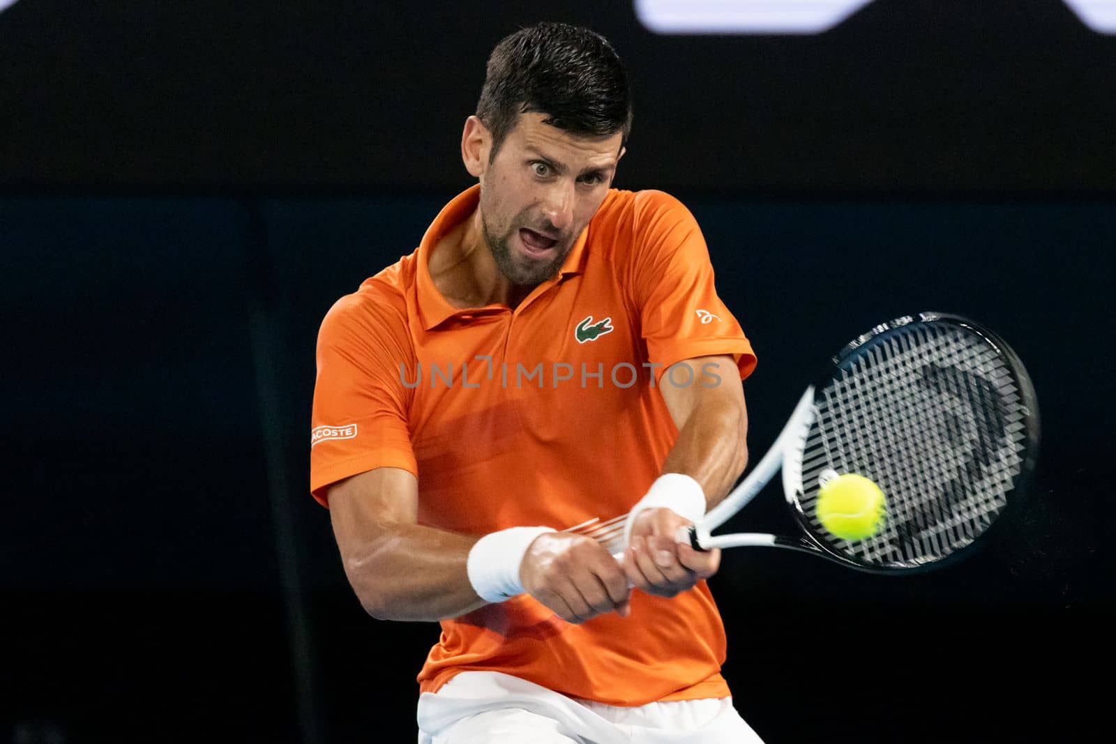 MELBOURNE, AUSTRALIA - JANUARY 13: Novak Djokovic of Serbia hits a shot to Nick Kyrgios of Australia in an Arena Showdown charity match ahead of the 2023 Australian Open at Melbourne Park on January 13, 2023 in Melbourne, Australia.