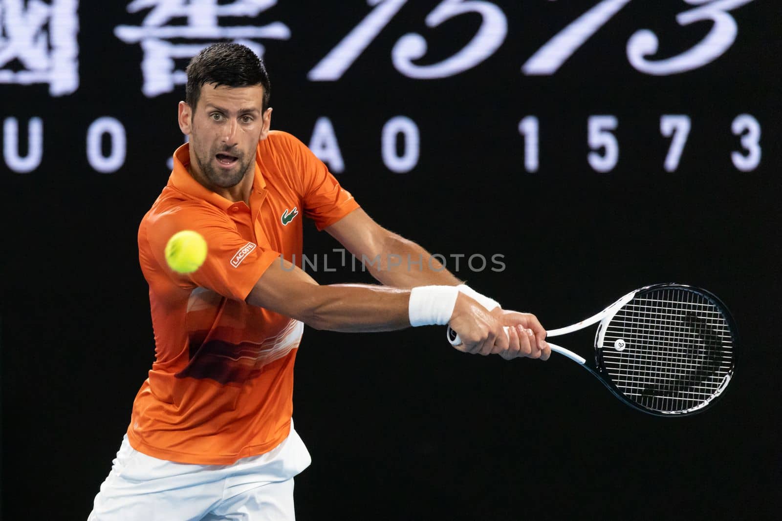 MELBOURNE, AUSTRALIA - JANUARY 13: Novak Djokovic of Serbia hits a shot to Nick Kyrgios of Australia in an Arena Showdown charity match ahead of the 2023 Australian Open at Melbourne Park on January 13, 2023 in Melbourne, Australia.