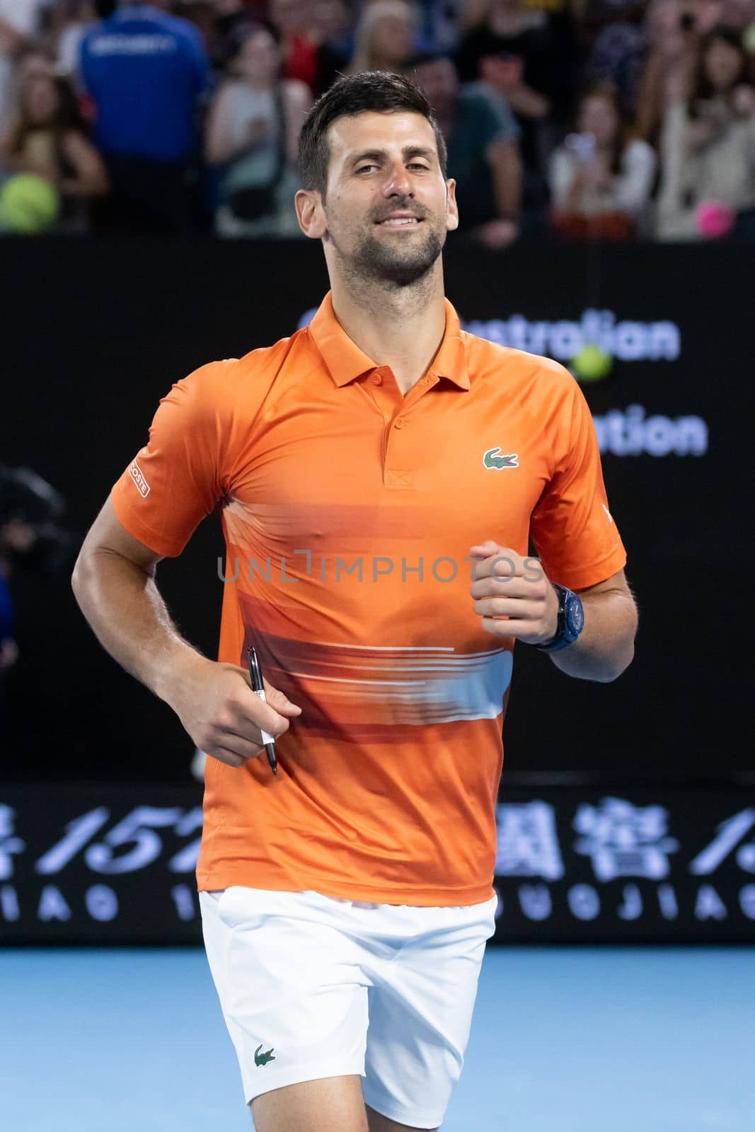 MELBOURNE, AUSTRALIA - JANUARY 13: Novak Djokovic of Serbia signs autographs after playing Nick Kyrgios of Australia in a showdown charity match ahead of the 2023 Australian Open at Melbourne Park on January 13, 2023 in Melbourne, Australia.