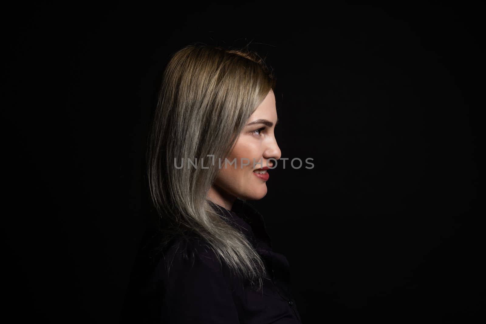 woman in black on a black background.