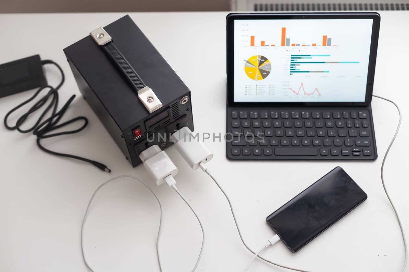 Charging station for phone, tablet, laptop and other gadgets when there is no light during blackout. Generator power bank battery in the absence of electricity. Charge electric rechargeable battery by Andelov13