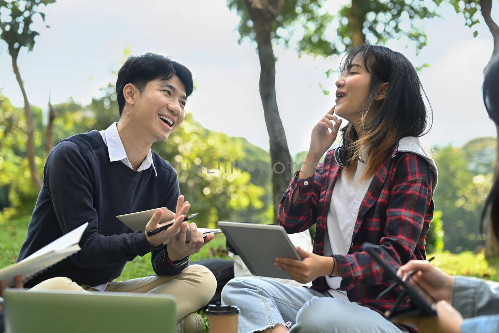 Group of students or teenagers with tablet doing homework at campus. Youth lifestyle and education concept by prathanchorruangsak