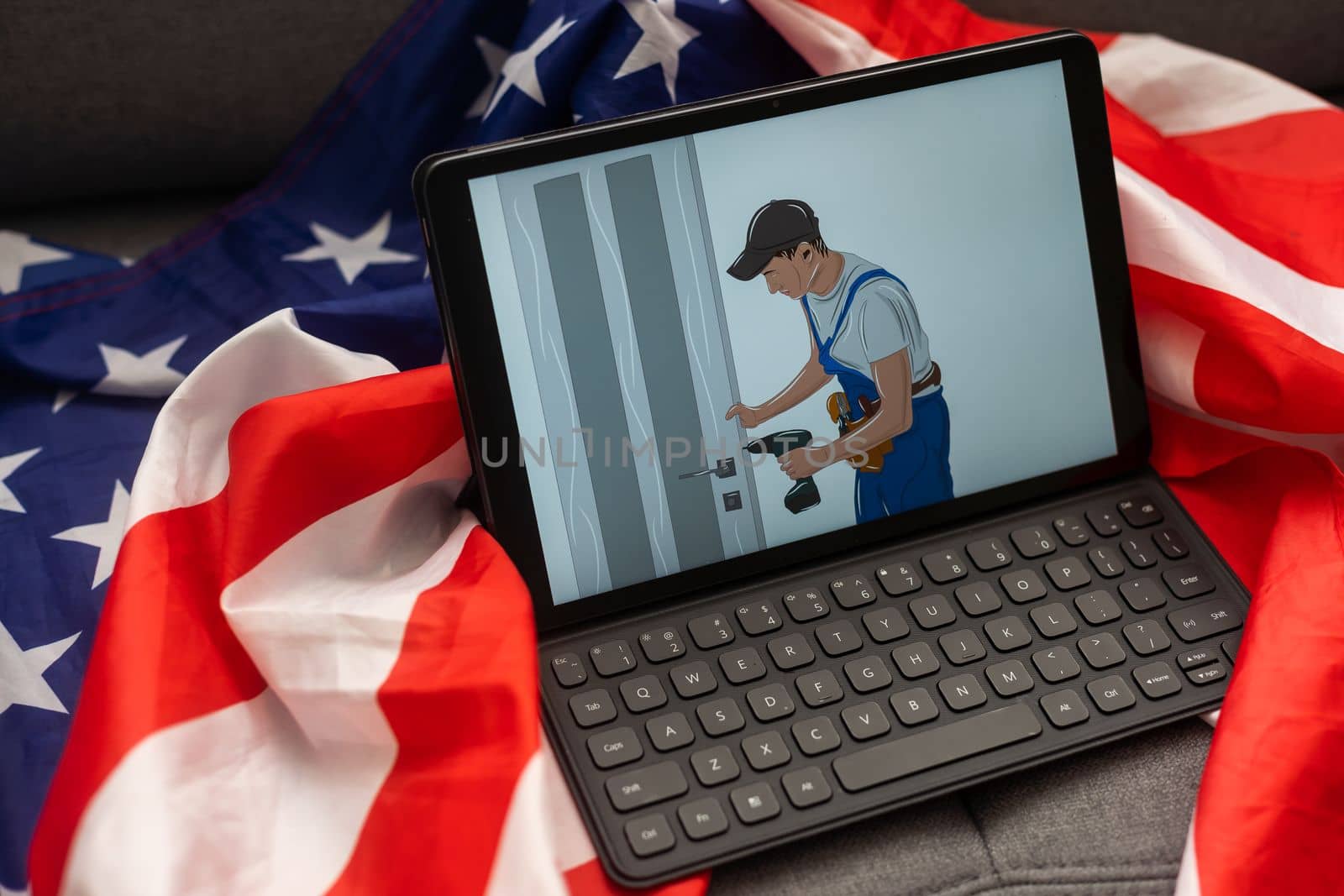 Tablet pc computer on american flag, technology, patriotism, anniversary, national holidays and independence day