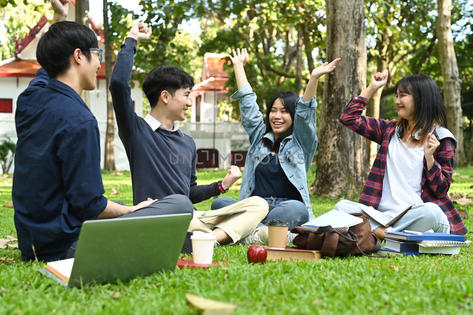 Cheerful female and male classmates having fun celebrating and laughing. Friendship, community, youth and university concept.