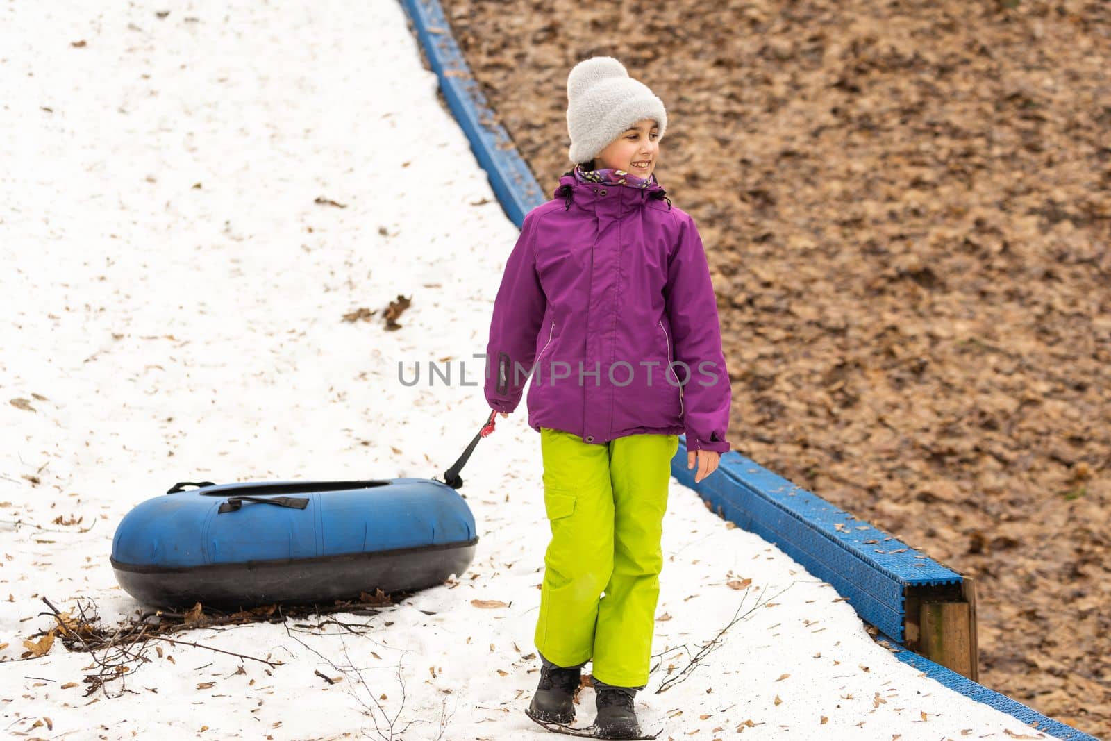 Children ride on tubing. Winter entertainment. Tubing. People roll on the slides