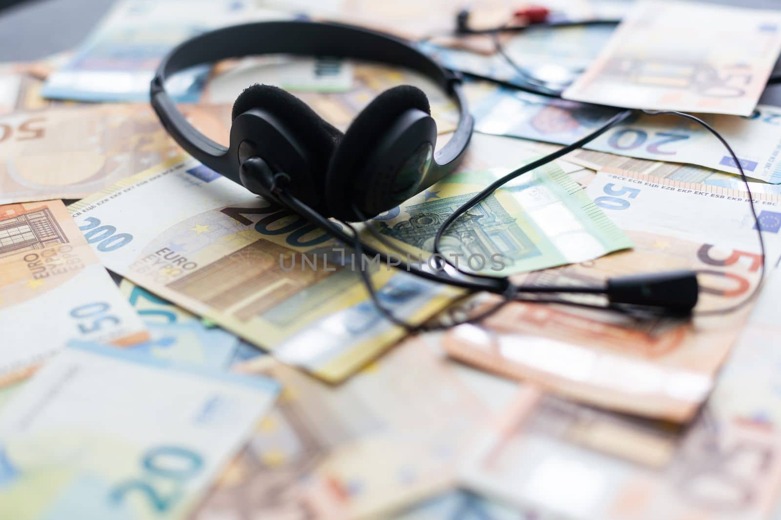 euro banknotes headphones headset. Money and technology still life concept