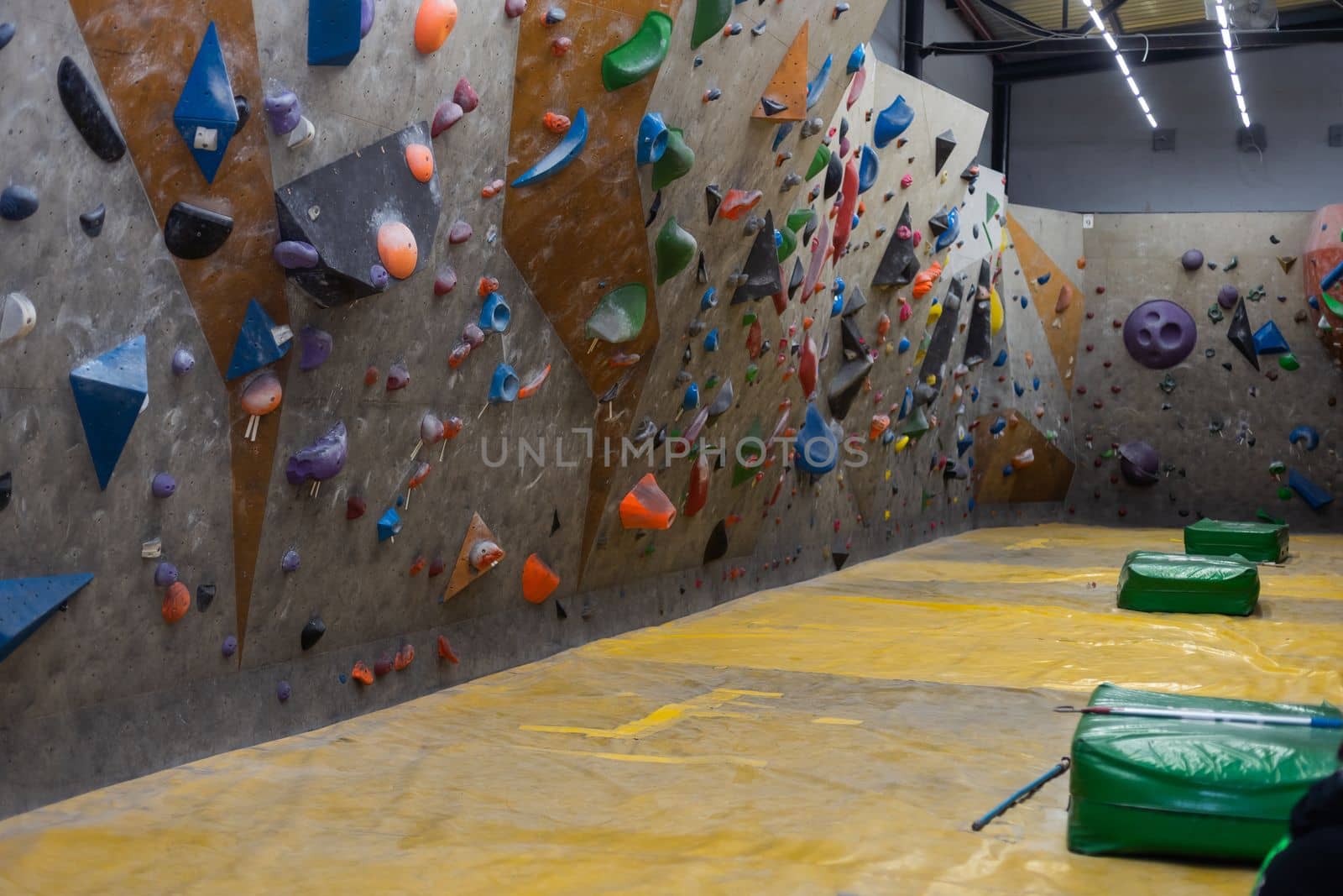 wall climbing wall, with protrusions, ropes and carbines.