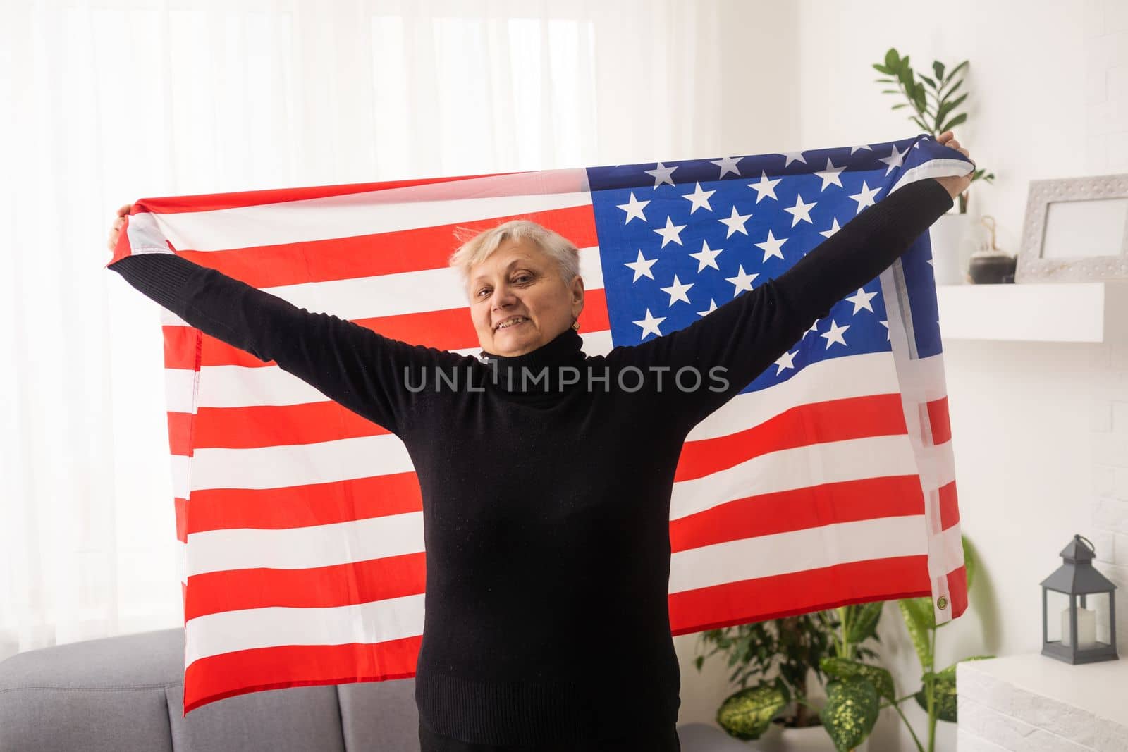 Charming mature woman in USA flag celebrating 4th of july. United States independency day. by Andelov13