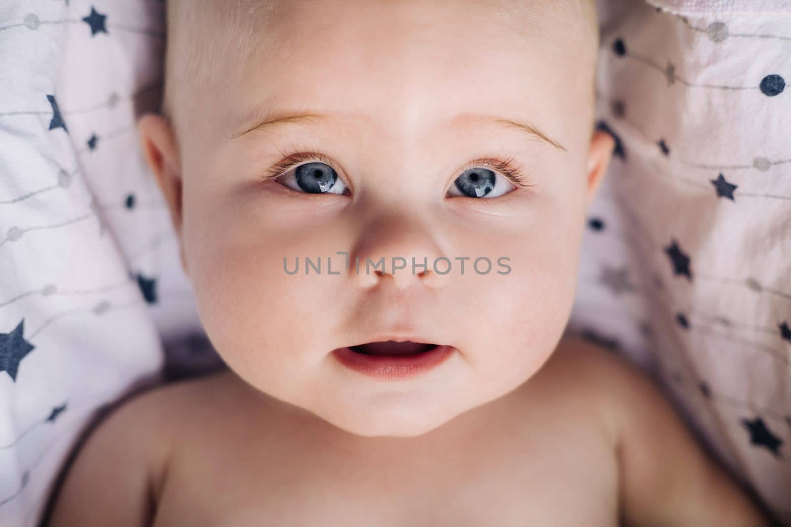 Close-up of the face of a cute baby lying in.