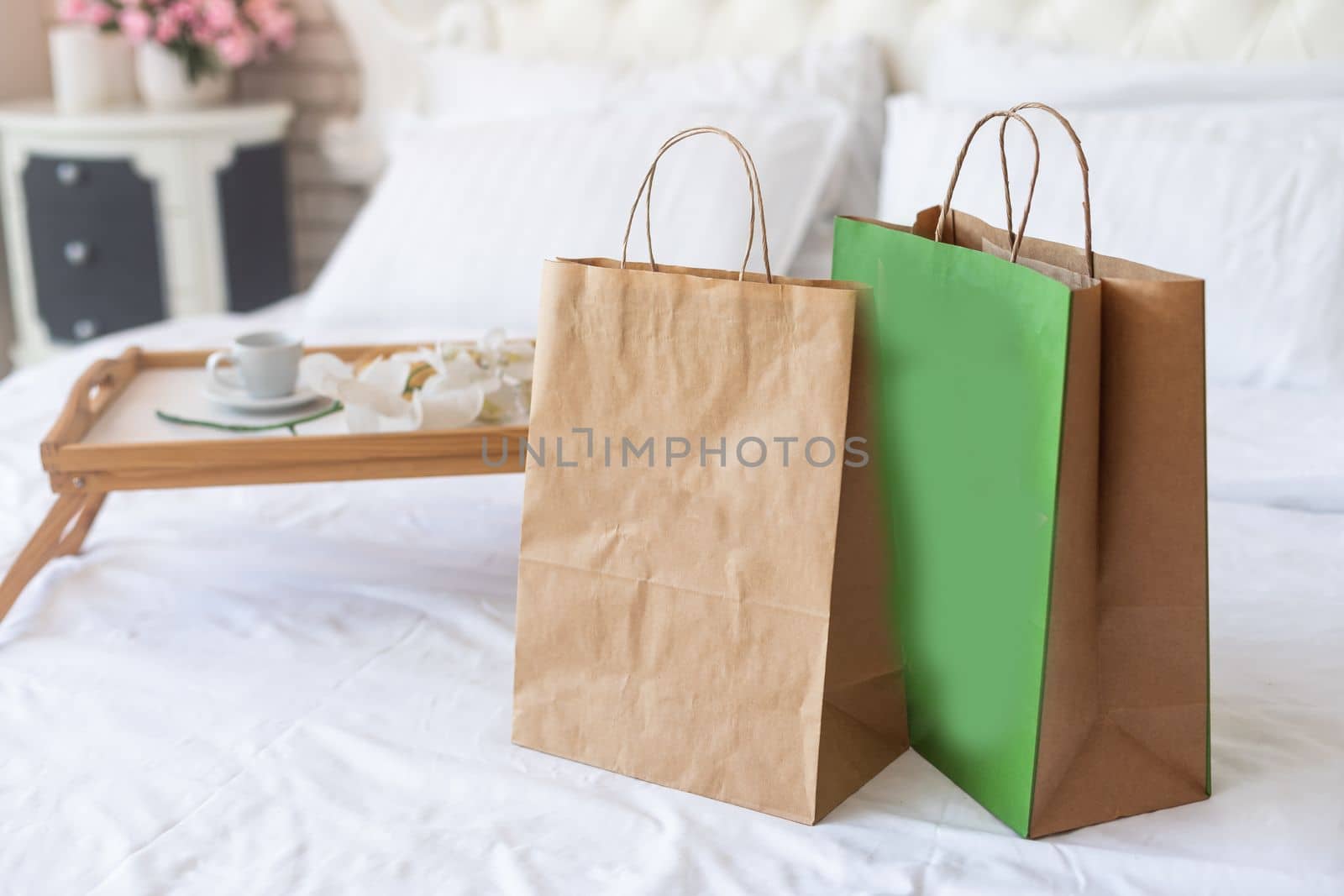 Paper bags on the bed. Online shopping home delivery concept