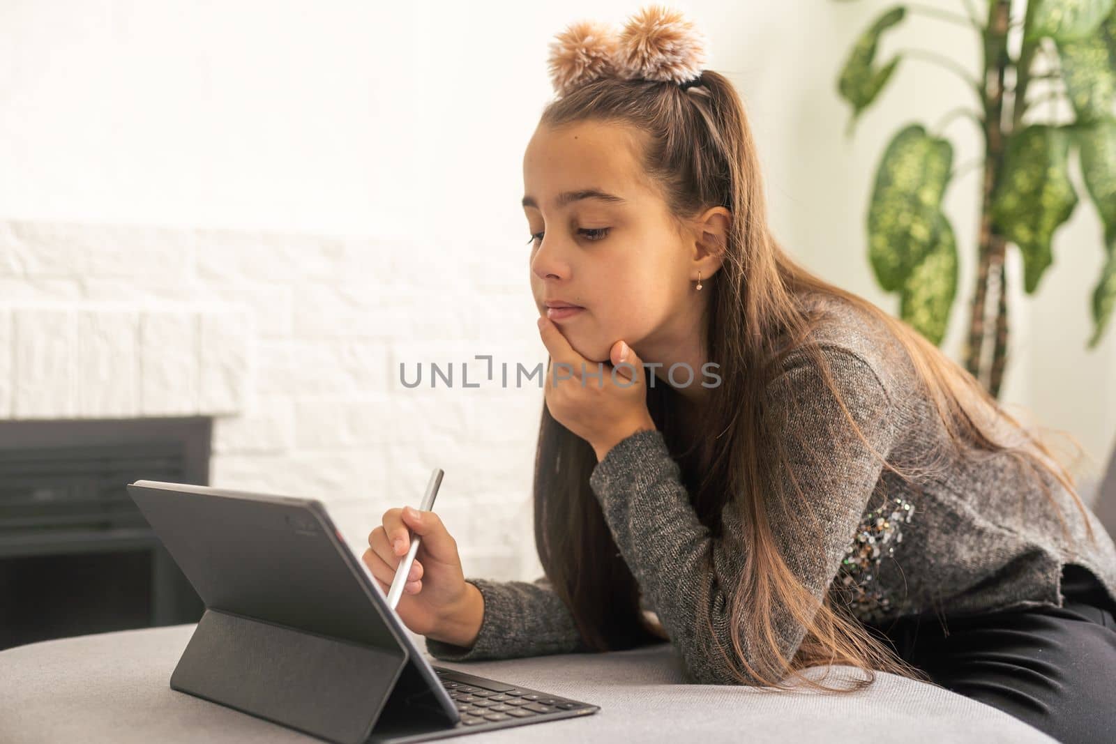 home, technology and internet concept - smiling teenage girl on the couch with tablet pc computer at home by Andelov13