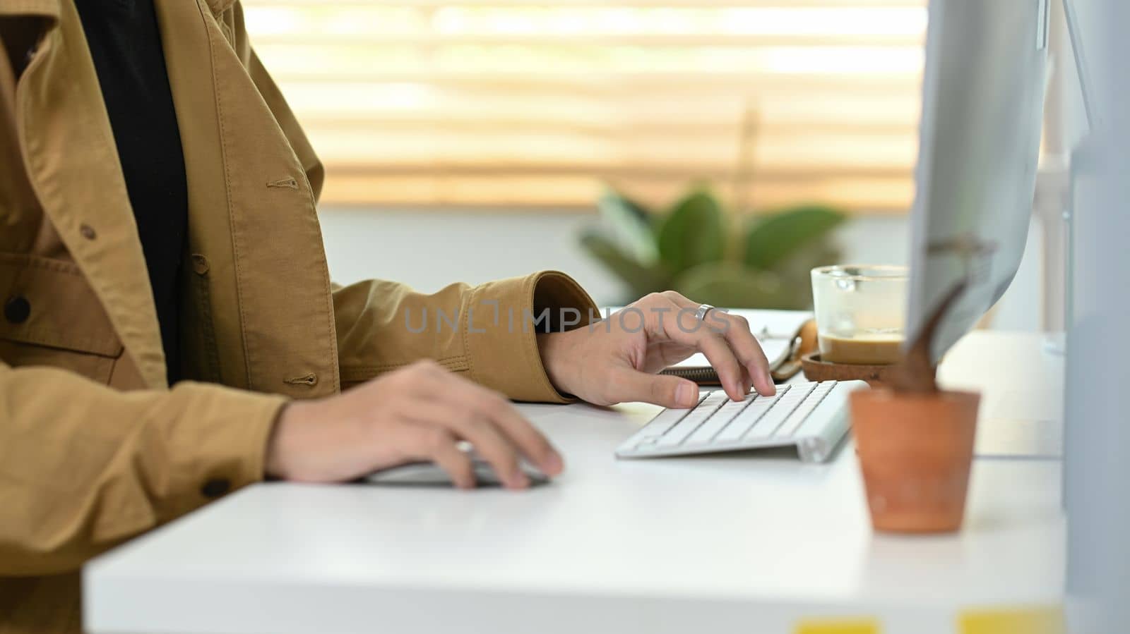 Cropped shot man working with computer in home office.