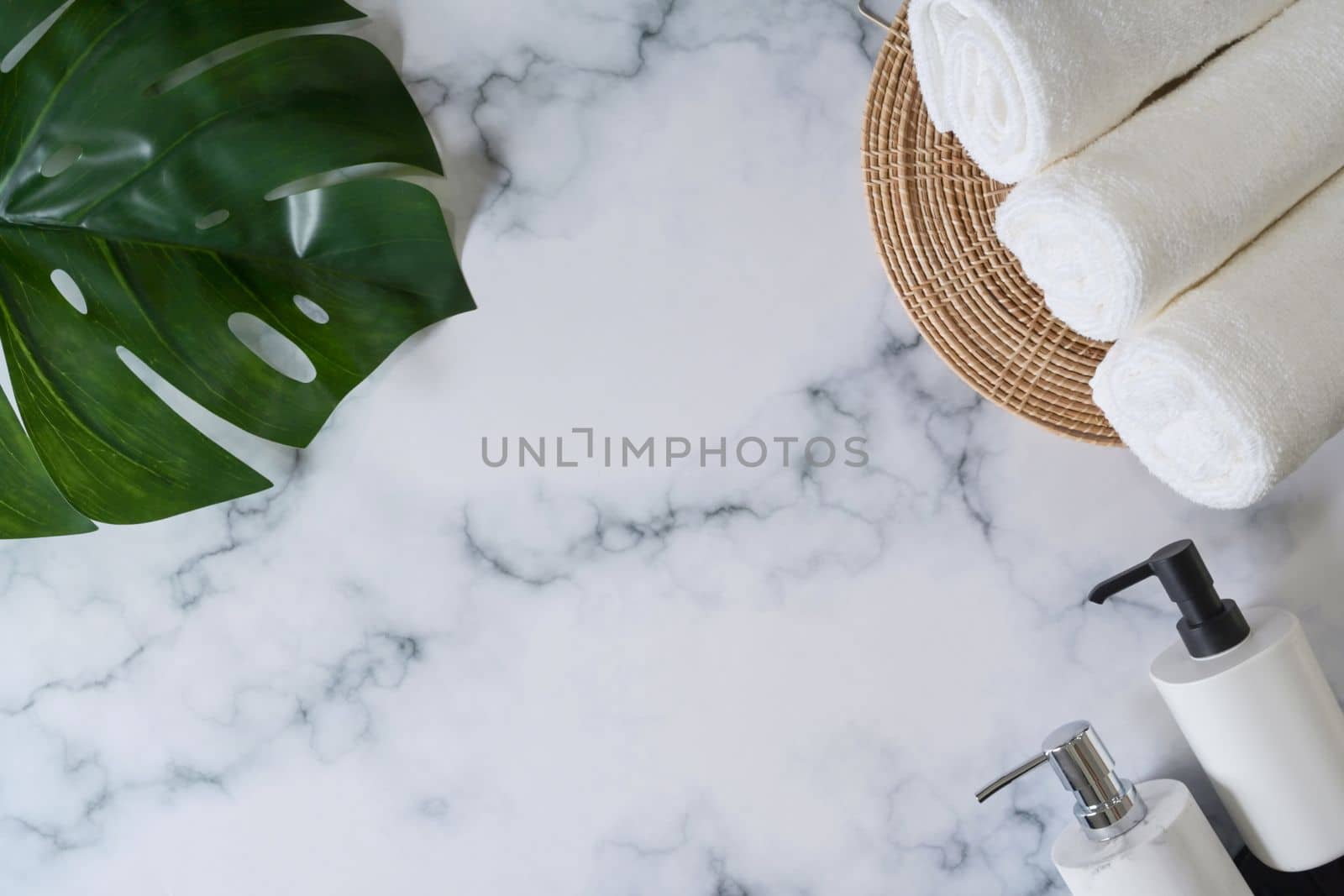Soap bottles and white towels on marble background. by prathanchorruangsak