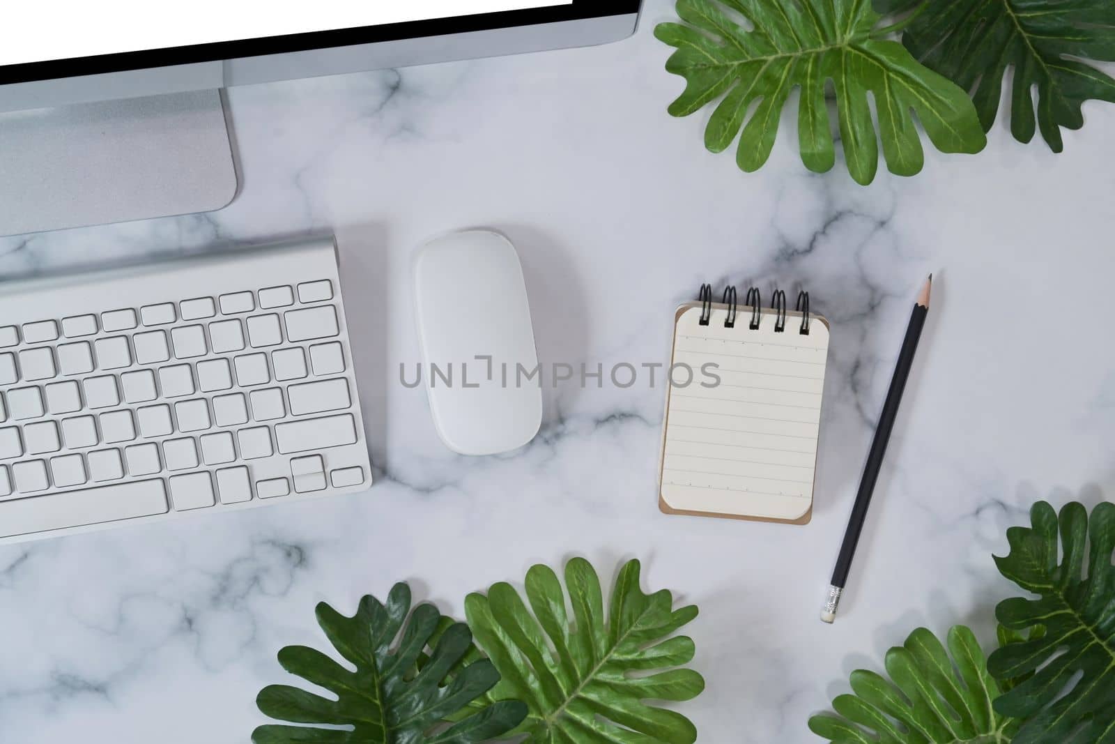 Empt notebook and computer on marble background. by prathanchorruangsak