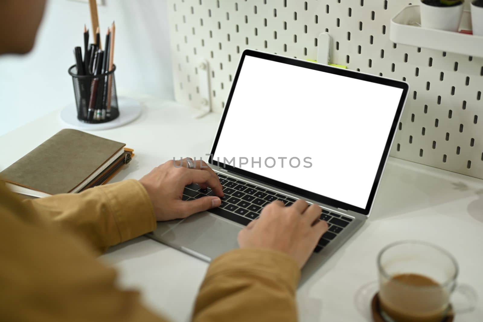 Male freelancer working online with computer laptop. by prathanchorruangsak