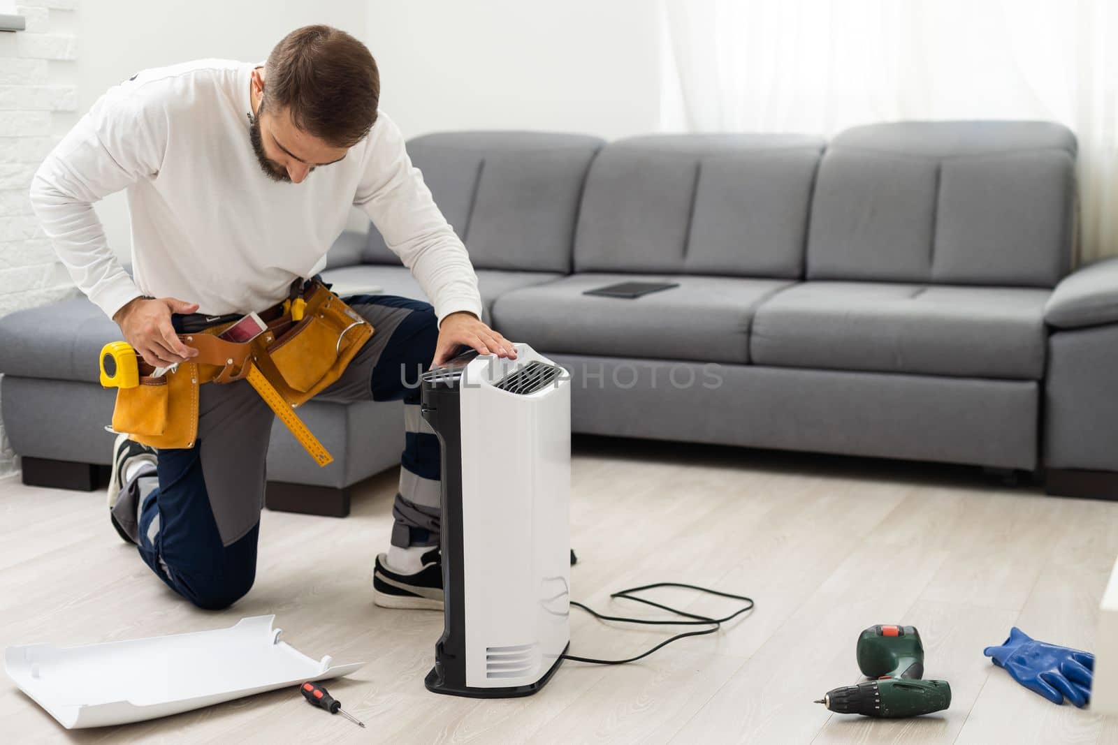 a man repairs an air purifier.