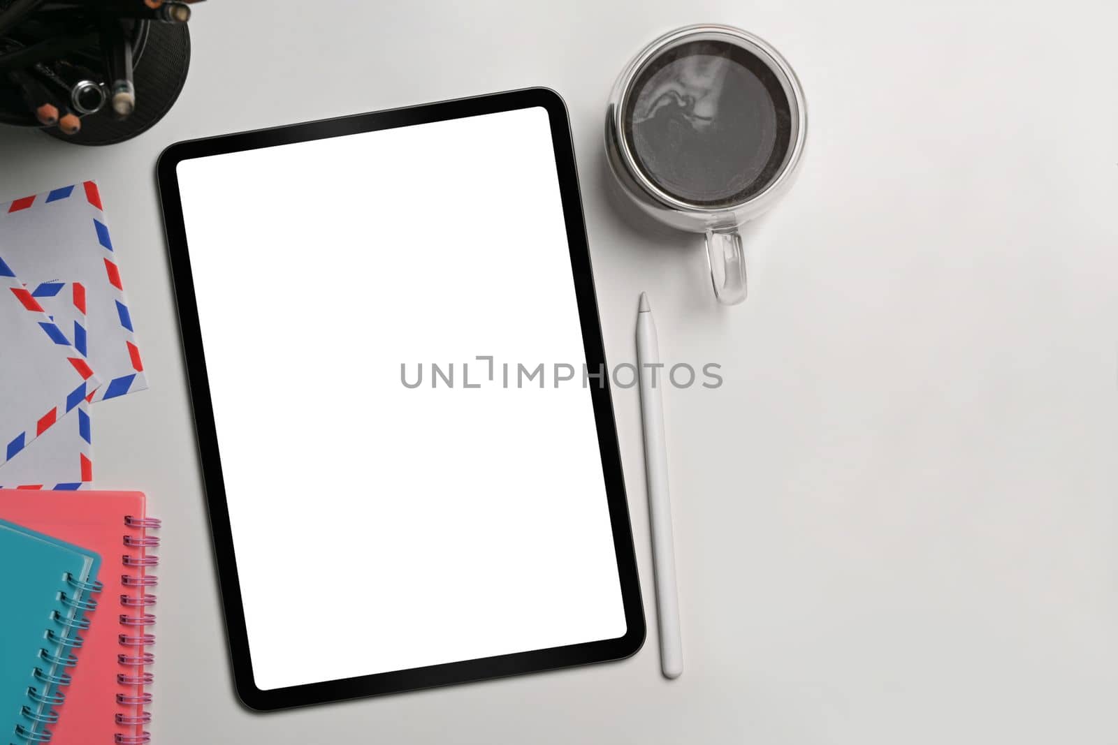 Digital tablet, stylus pen, notebook and coffee cup on white background. Flat lay.