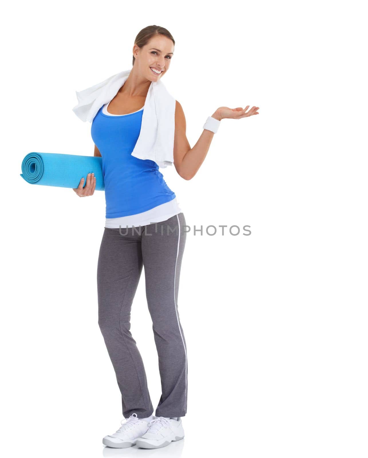 Heres the answer to your fitness needs...Fit young woman holding a pilates mat with a smile - isolated on white