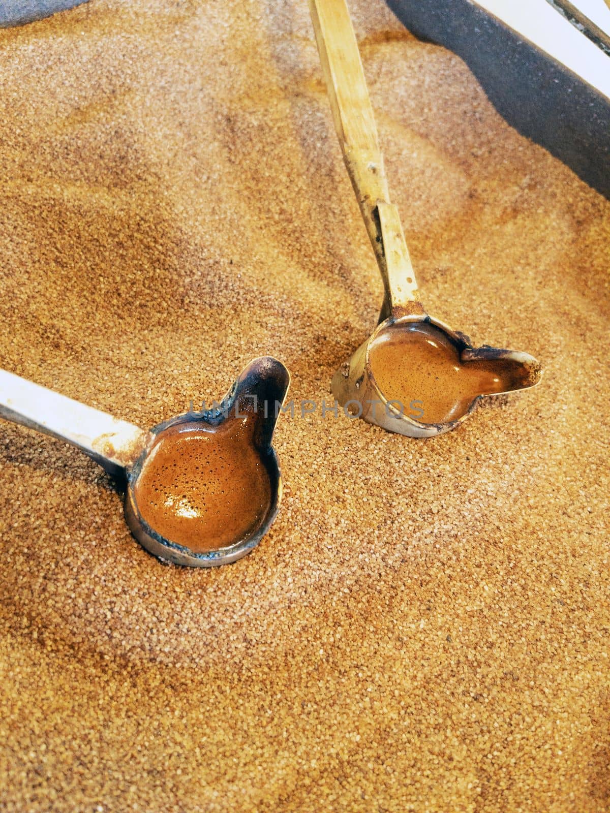 Preparation of natural coffee in Turks on the sand. Turkish coffee