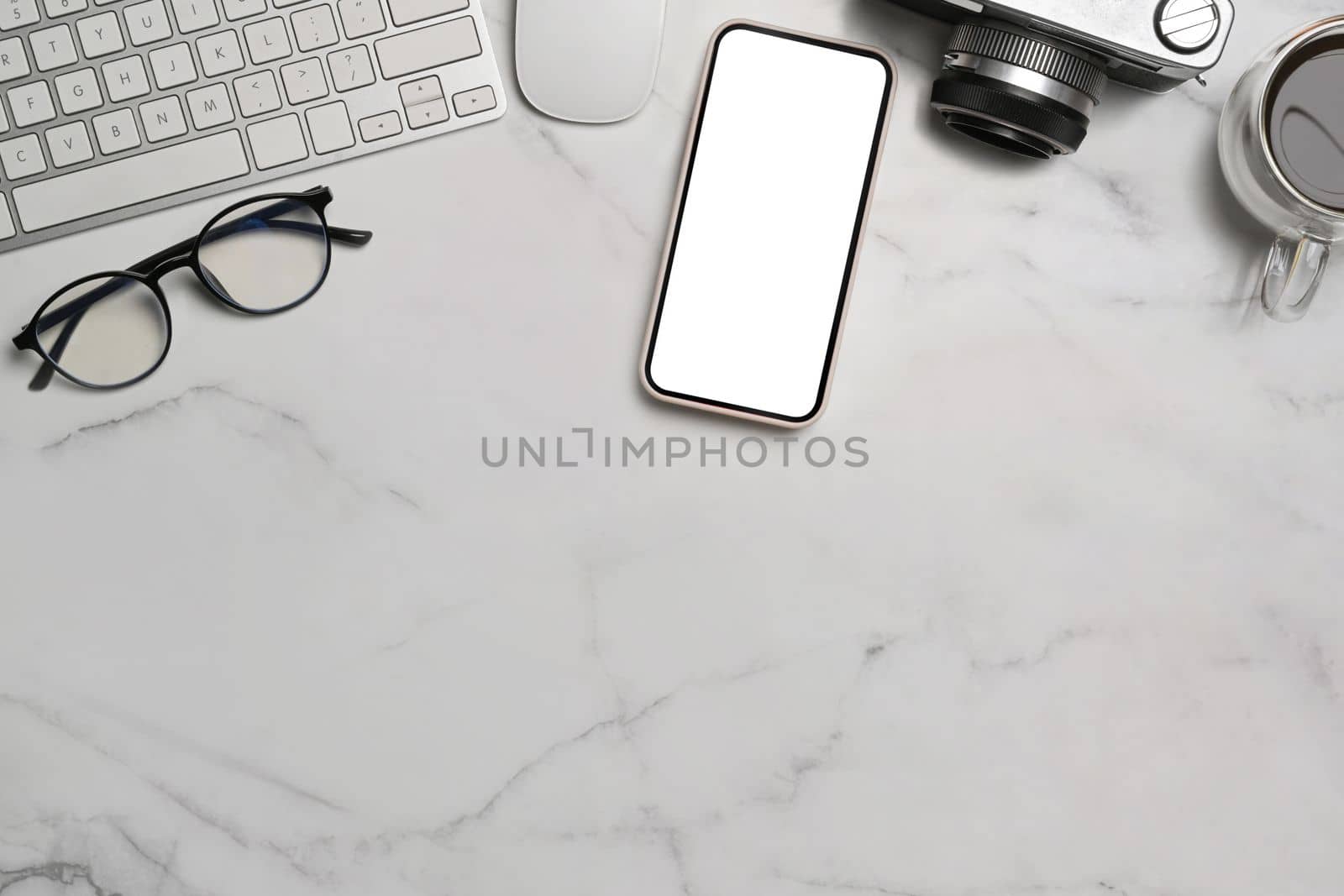 Mock up mobile phone, camera, glasses and coffee cup on marble background. by prathanchorruangsak