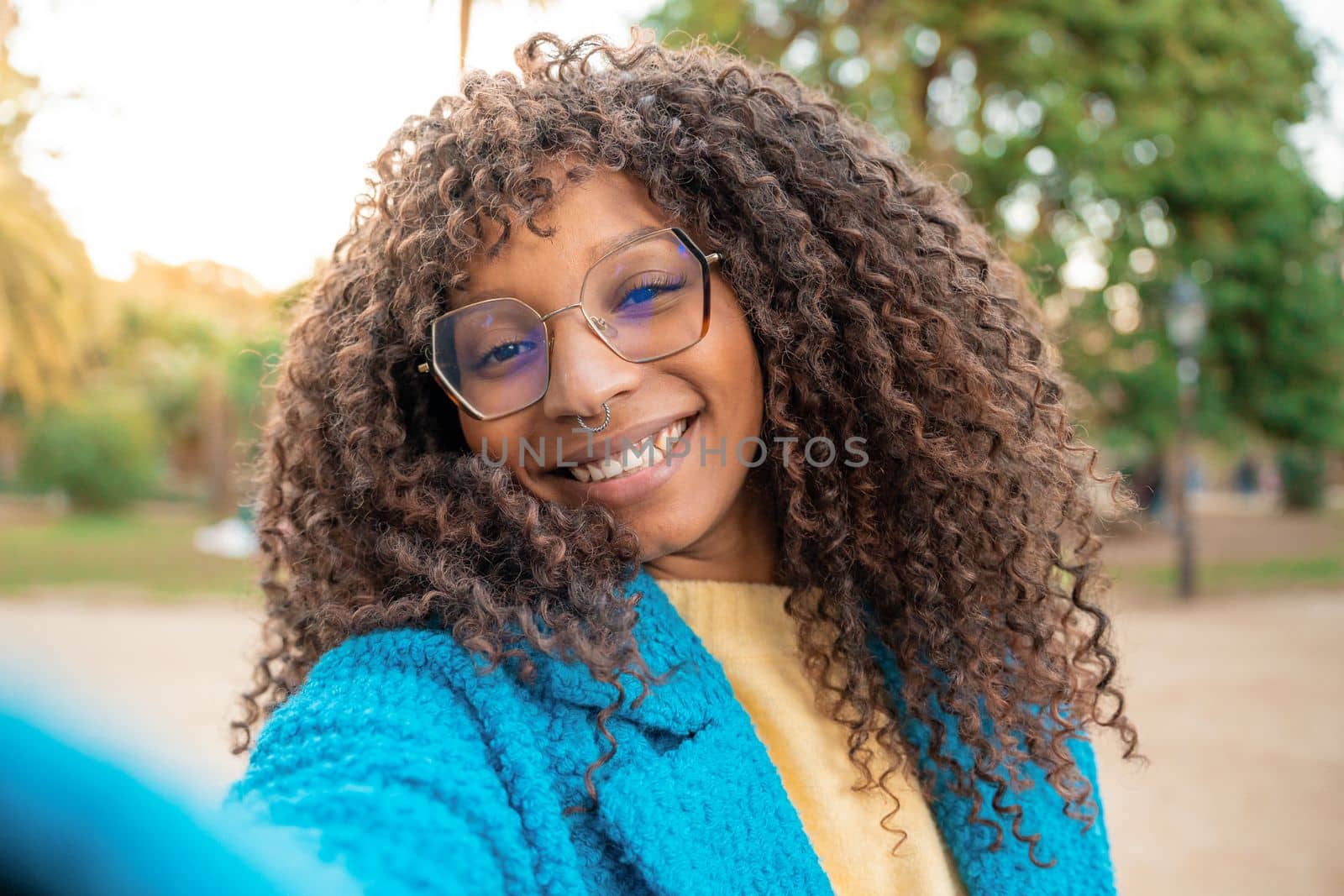 African American woman smiling taking selfie. Positive cheerful trendy girl posing by PaulCarr