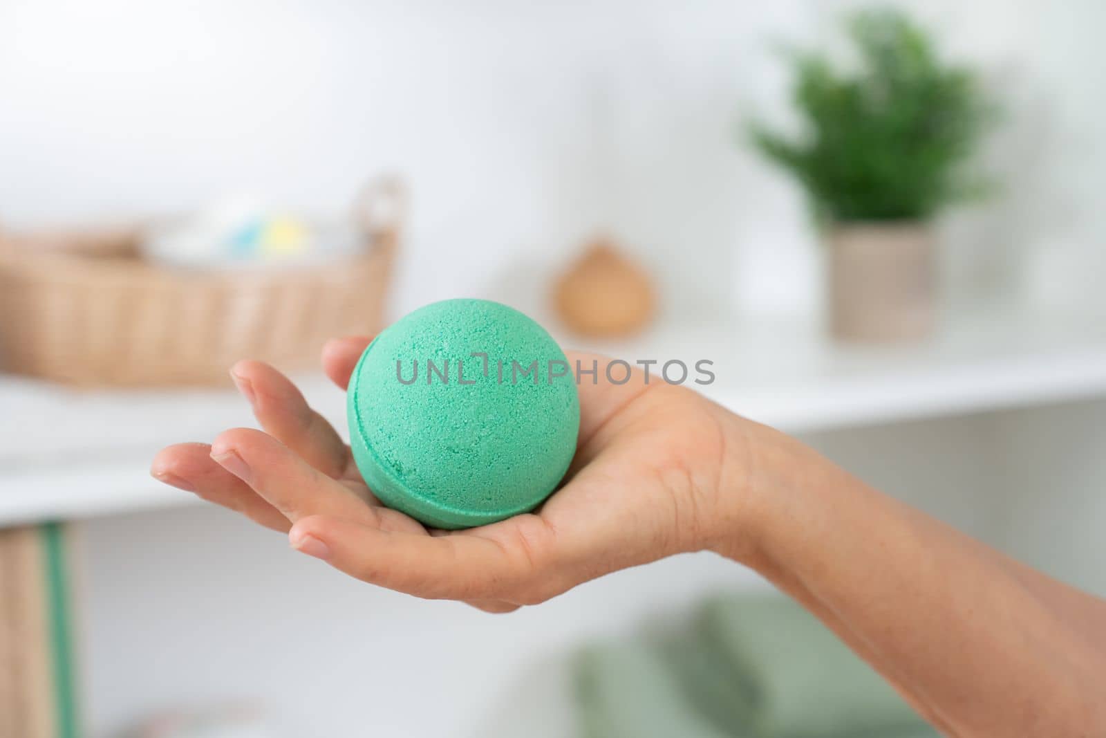 Closeup of a woman's hand with soap ball in the bathroom for skin and body care. Cosmetic concept. by PaulCarr