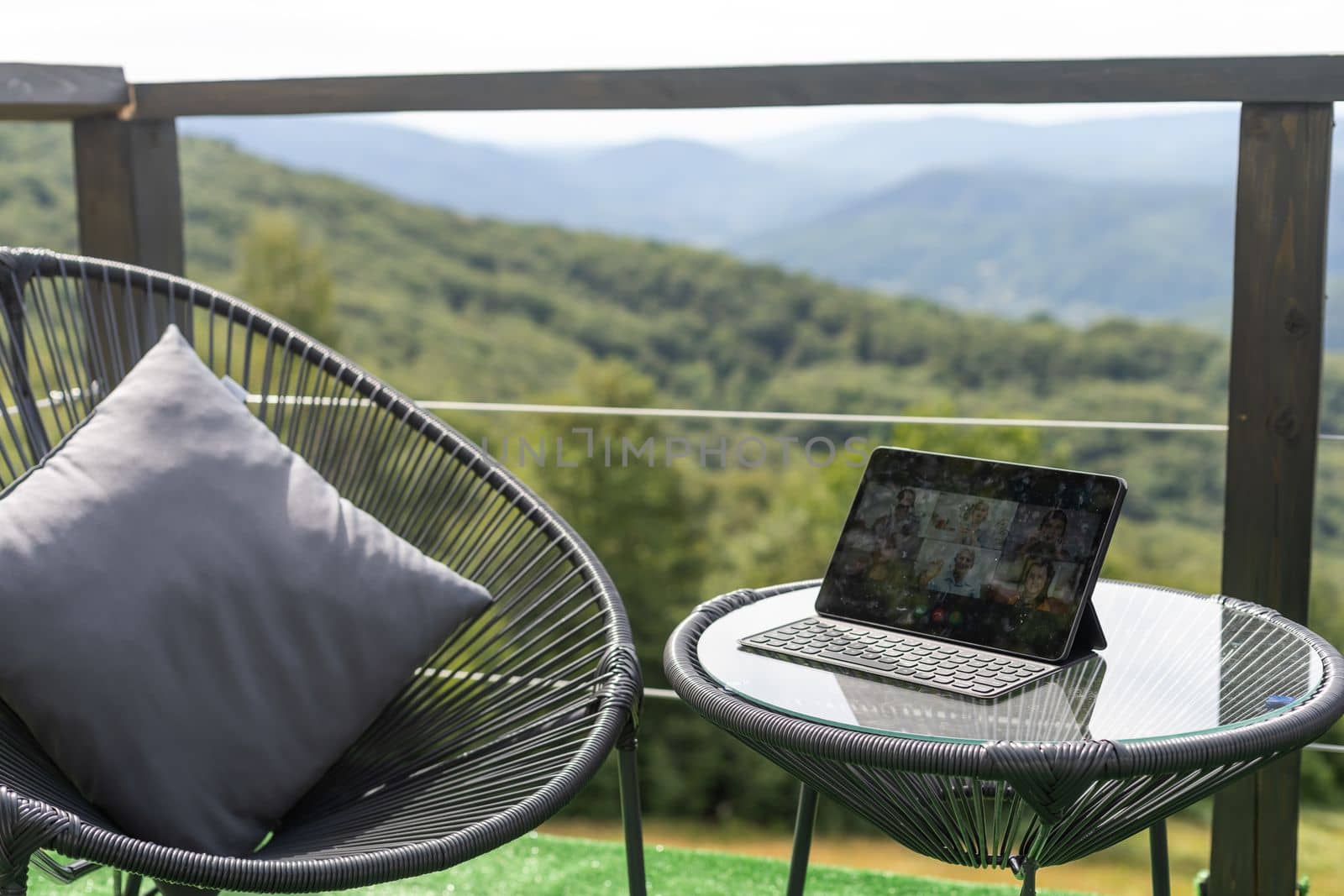 Laptop on terrace with white screen and mountains blurred as a background. by Andelov13