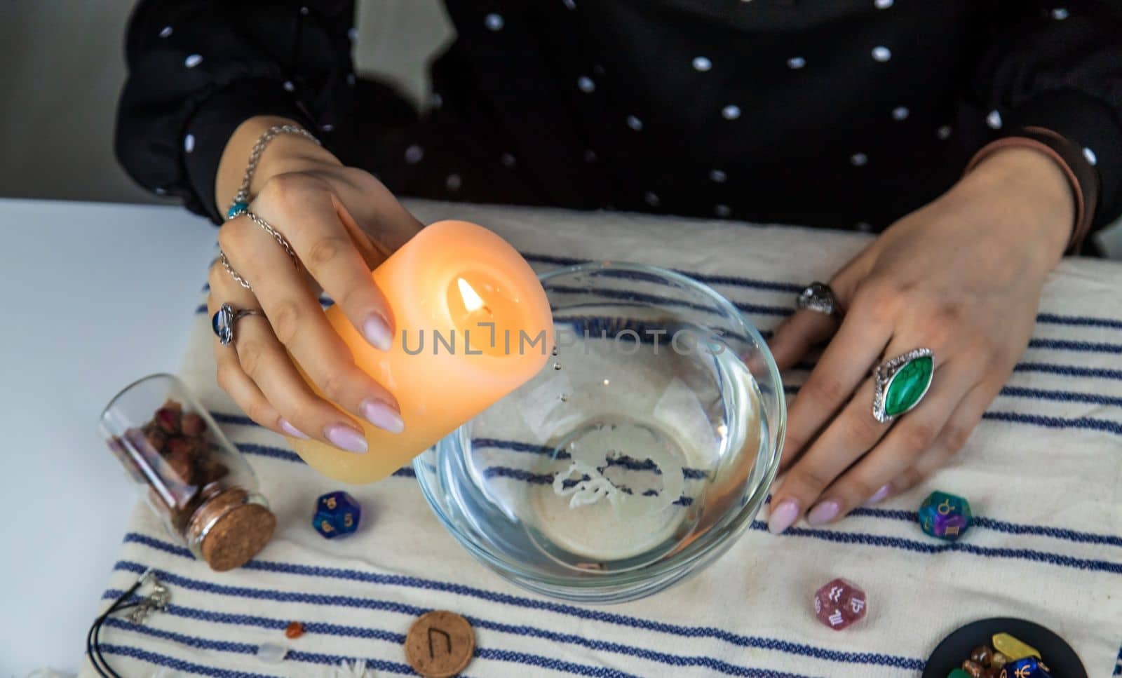 Woman fortune teller fortune telling wax candles. Selective focus. people.
