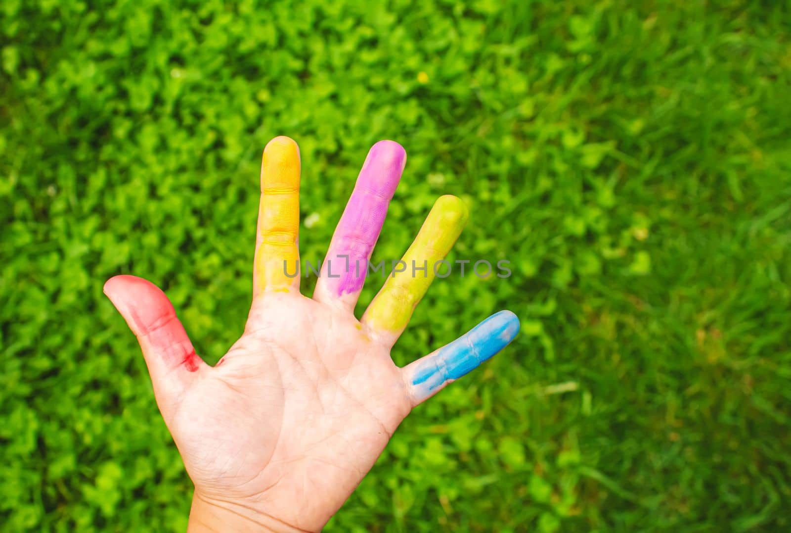 Children's hands in the colors of summer. Selective focus.arts
