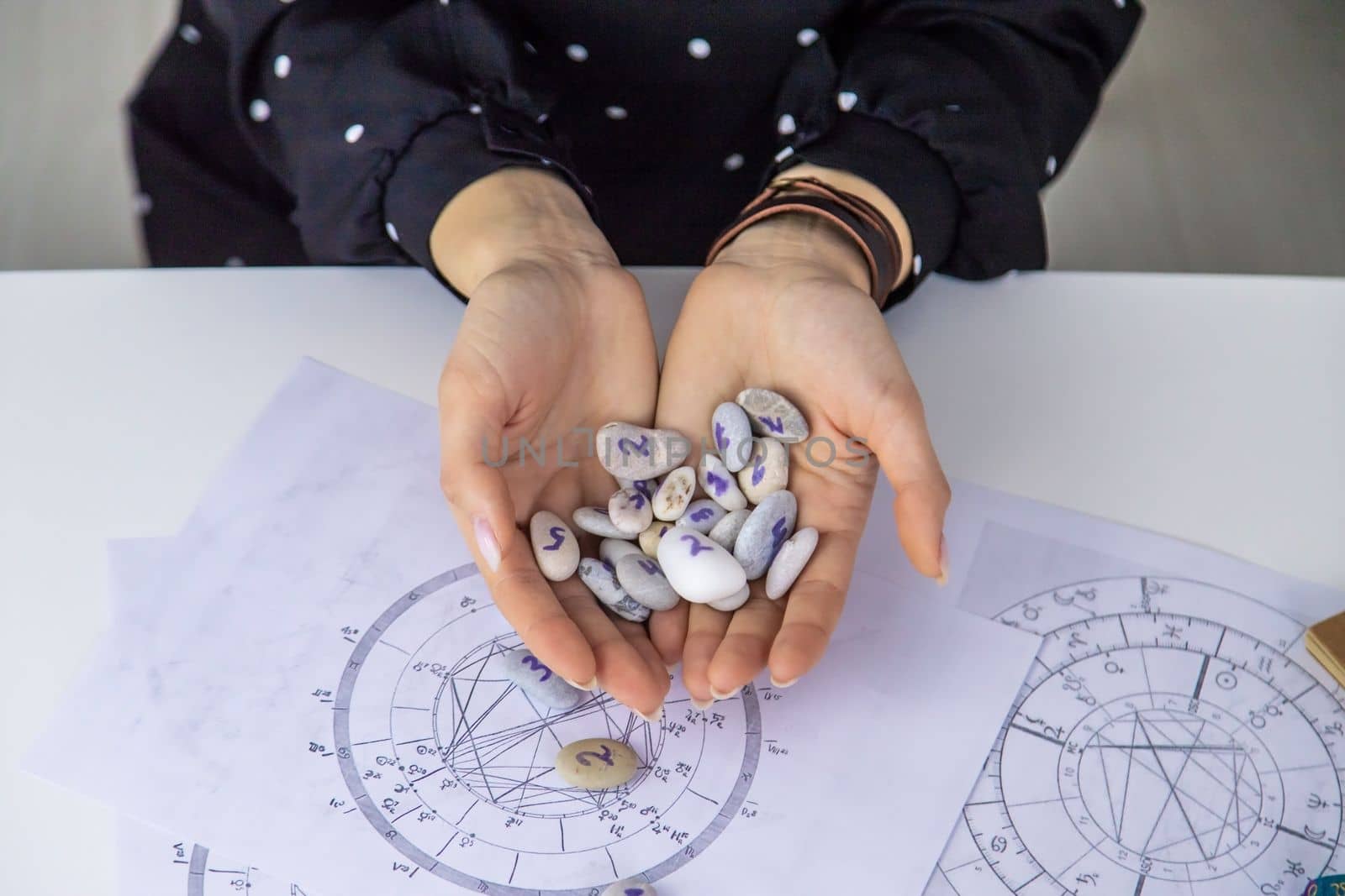 Woman numerologist astrologer counts numbers. Selective focus. People.