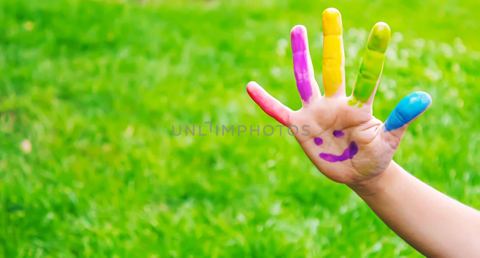 Children's hands in the colors of summer. Selective focus.arts