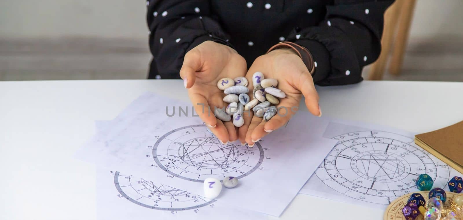 Woman numerologist astrologer counts numbers. Selective focus. People.