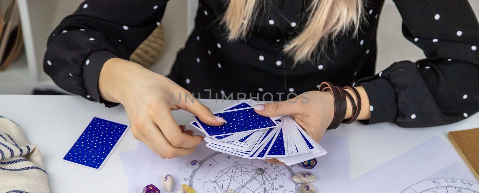 Woman astrologer draws a natal chart. Selective focus. People.