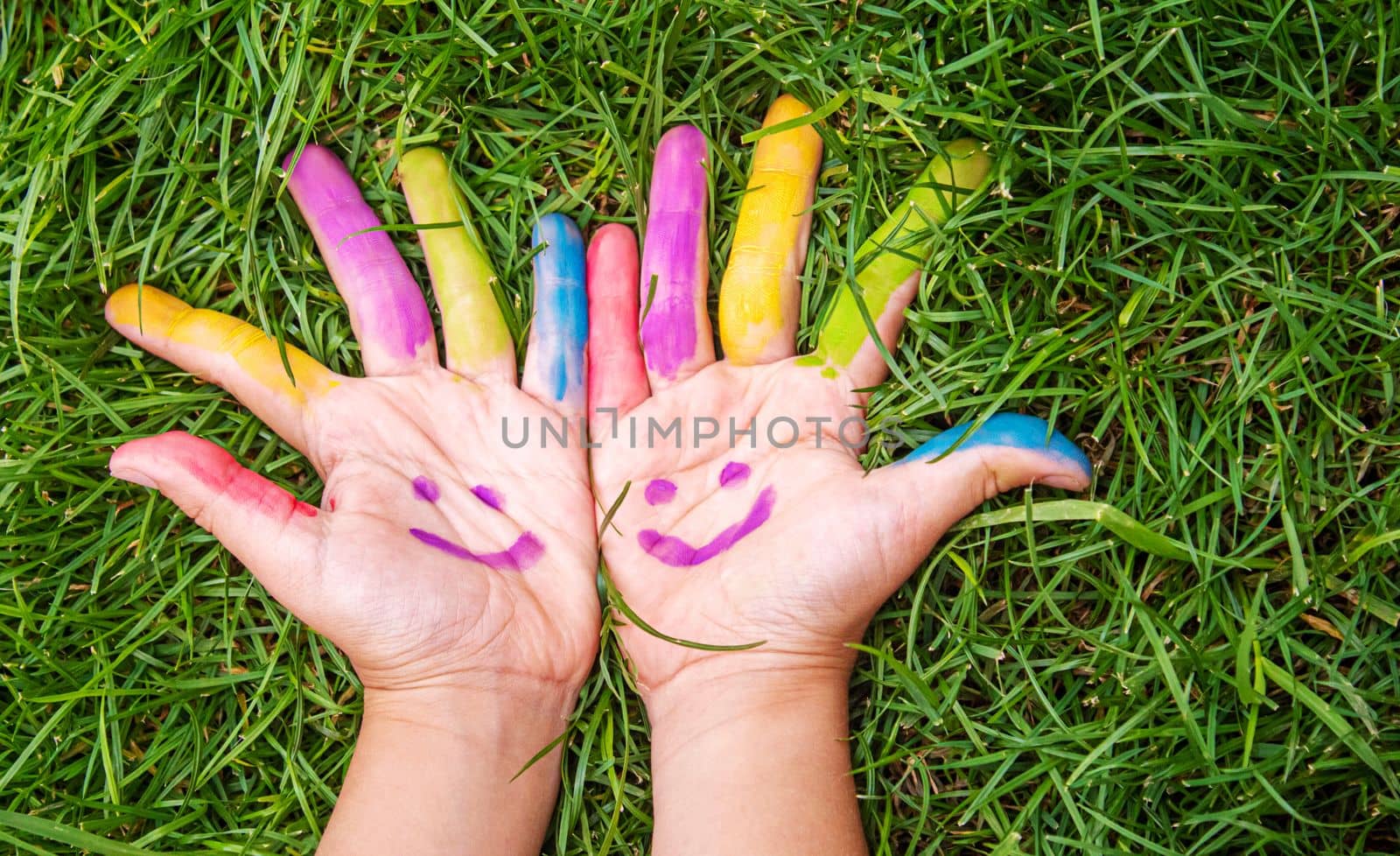 Children's hands in the colors of summer. Selective focus.arts